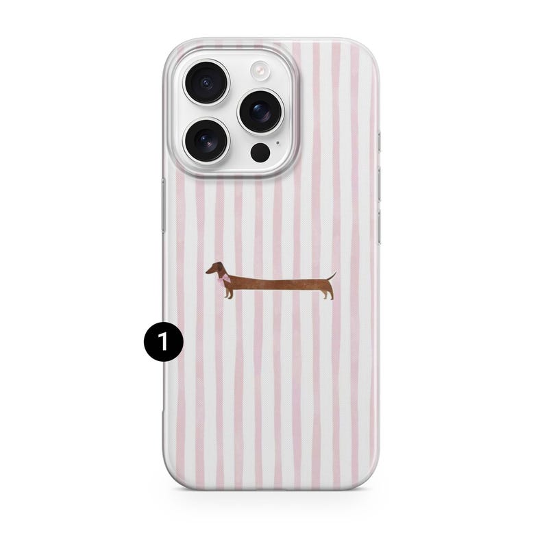 May include: Clear phone case featuring a pink and white striped design. A brown dachshund dog with a pink collar is depicted. The case has cutouts for the camera and side buttons.