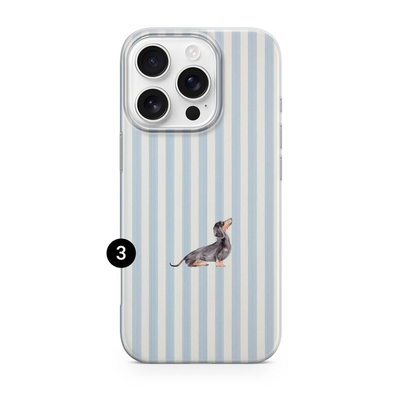 May include: A clear phone case featuring a light blue and white striped design. The case has a watercolour illustration of a dachshund dog. The phone case is designed to fit a smartphone.