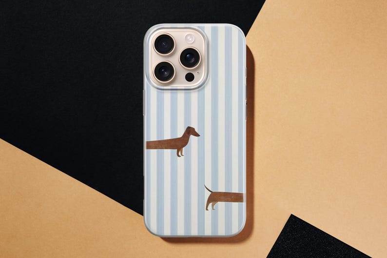 May include: A smartphone case with a light blue and white striped design. The case features two brown dachshund illustrations. The phone case is shown on a black and tan background.