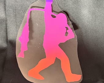 May include: A gradient sticker featuring a silhouette of a person holding a fish. The figure is colored in shades of pink, orange, and purple. The sticker has a clear border and is set against a dark background.