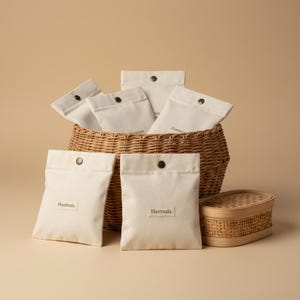 May include: A set of three ceramic mugs with a speckled, matte finish. The mugs are in shades of cream, light gray, and dark gray. Each mug has a simple, minimalist design, perfect for coffee or tea.