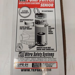 May include: A product box for an Ultra Bilge USS Pumpswitch Senior. The box features text and graphics, including "10 Year Warranty" and "Environmentally Safe." The product is designed with a self-cleaning, clog-proof design and adhesive-filled heat shrink wire connectors.
