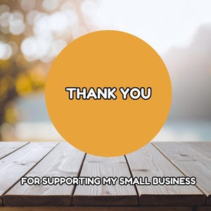 May include: An image with a wooden table in the foreground and a blurred background. A large orange circle in the center displays the words "THANK YOU" in a bold, black font. Below, the text reads "FOR SUPPORTING MY SMALL BUSINESS."