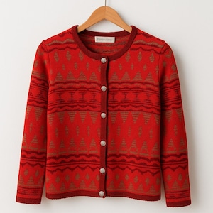 May include: A red cardigan with a geometric pattern in brown and red. The sweater has a round neckline, long sleeves, and silver buttons. The brand name "PENDLETON" is visible on the neckline. The cardigan is a classic style.