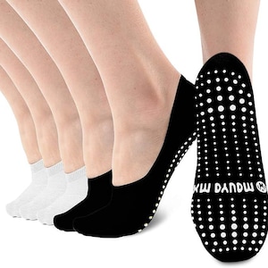 May include: A selection of no-show socks in white and black. The black socks have white dotted grips on the soles. The socks are designed to be worn with shoes that expose the top of the foot.