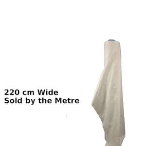 May include: A roll of off-white fabric, 220 cm wide, with a portion unrolled. The text "220 cm Wide Sold by the Metre" is visible. The fabric appears to be a natural fiber.