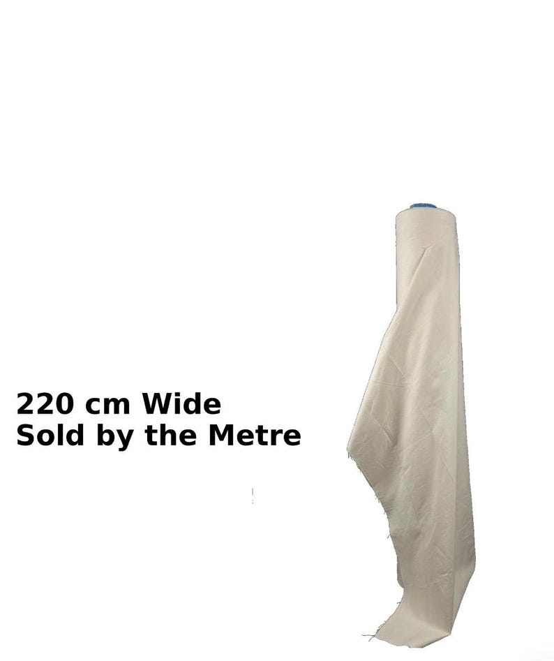 May include: A roll of off-white fabric, 220 cm wide, with a portion unrolled. The text "220 cm Wide Sold by the Metre" is visible. The fabric appears to be a natural fiber.