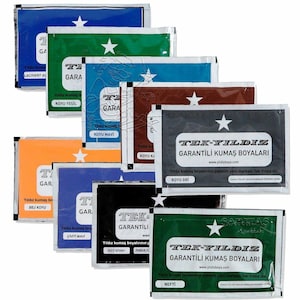 May include: A selection of fabric dye sachets in shades such as blue, green, brown, and black. Each sachet displays the text "TEK-YILDIZ GARANTİLİ KUMAŞ BOYALARI" and a star. The packets are arranged in a slightly overlapping pattern.