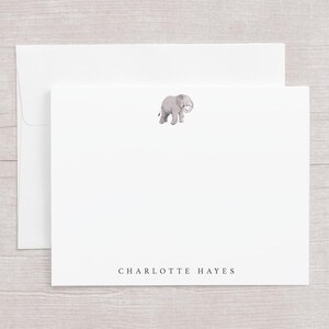 May include: White stationery set featuring a watercolor illustration of a gray elephant. The set includes a folded card and an envelope. The name "CHARLOTTE HAYES" is printed in a simple font at the bottom of the card.