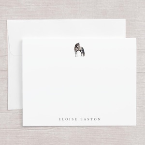 May include: White stationery set featuring a watercolor illustration of a horse. The set includes a folded card and an envelope. The name "Eloise Easton" is printed in a serif font at the bottom of the card.