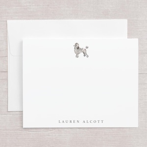 May include: White stationery set featuring a watercolor illustration of a poodle. The set includes a folded card and an envelope. The name "LAUREN ALCOTT" is printed in a simple font at the bottom of the card.