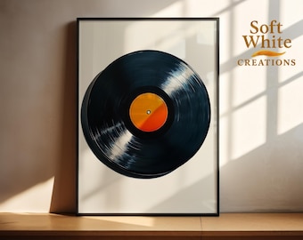 May include: A framed print featuring a vinyl record. The record is black with a yellow and orange center label. The artwork is displayed in a black frame against a neutral background. The text "Soft White Creations" is in the upper right corner.