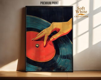May include: A framed art print featuring a stylized illustration of a hand touching a vinyl record. The record is red and teal, with a black background. The words "PREMIUM PRINT" are at the top. The Soft White Creations logo is on the right.