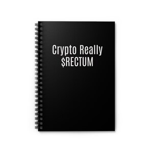 May include: Black spiral-bound notebook with the text "Crypto Really $RECTUM" in white. The notebook has a black cover and white pages. The spiral binding is silver.
