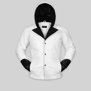 May include: A white hooded jacket with black accents. The jacket features a black hood lining, a black collar, and black cuffs. It has three buttons down the front and two pockets. The jacket is a modern take on a classic design.