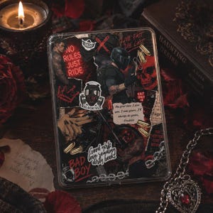 May include: A clear phone case with a collage design featuring a skull, biker, and various text elements. The case has a dark, edgy aesthetic with red and black accents. Text includes "NO RULES JUST RIDE" and "BAD BOY".