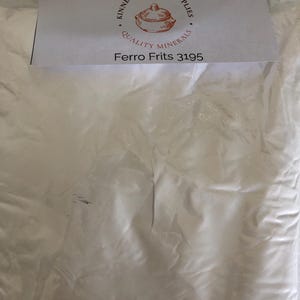 May include: A clear plastic bag filled with white powder. A white label at the top reads "Kinney Ceramic Supplies, Quality Minerals" with a graphic of a pot. Below the graphic is the text "Ferro Frits 3195".