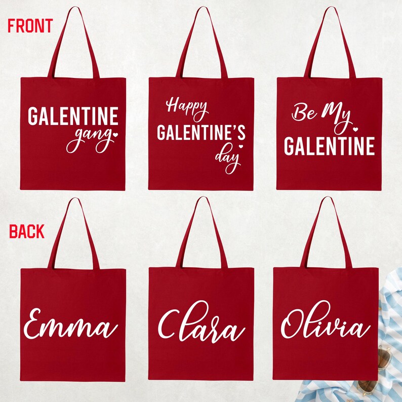 May include: Red tote bags with white text. The front of the bags say "GALENTINE gang", "Happy GALENTINE'S day", and "Be My GALENTINE". The back of the bags say "Emma", "Clara", and "Olivia".