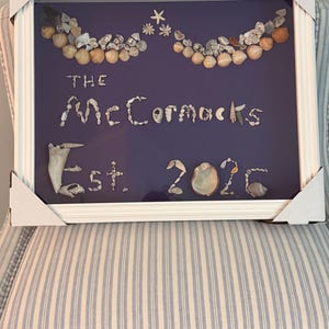 Personalized seashell art in shadowbox
