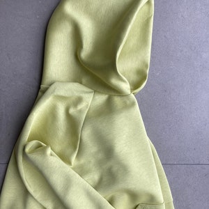 Side close up. Oversize hoodie. Without logos. Color citric yellow