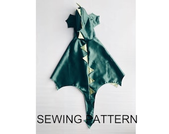 May include: A green and gold dragon costume sewing pattern. The pattern includes a hooded cape with a long tail and a spine of gold triangles.