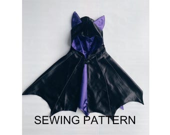 May include: A black bat costume with purple satin lining and ears. The costume has a hood and wings.