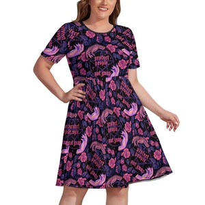 May include: A black dress with a short sleeve design. The dress features a repeating pattern of hands, roses, and text that reads "Protect people, not guns" in a gothic font. The dress has a round neckline.