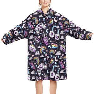 May include: A dark navy blue oversized hoodie with a repeating pattern of rainbows, flags, game controllers, hearts, and the text "LOVE IS LOVE". The hoodie has long sleeves and a hood.