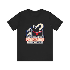 May include: A black short-sleeved t-shirt featuring a graphic of a hand reaching towards a red velvet rope barrier with a padlock. The text reads: IF YOUR NEWS NEEDS PERMISSION, IT ISN'T NEWS. A microphone and notepad are visible on the left side.