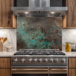 May include: A kitchen with a stainless steel gas range and a decorative backsplash. The backsplash features a mottled pattern of brown and teal colors. Wooden cabinets and a stainless steel range hood complete the kitchen design.
