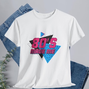 This “80s Made Me” retro t-shirt is the perfect throwback for anyone who grew up on cassette tapes, arcade games, and classic pop culture. Designed with a vintage-inspired graphic and timeless unisex fit, this tee delivers comfort and nostalgia in one iconic look. Easy to style with jeans, jackets, or sneakers, it’s a go-to everyday shirt for retro lovers and pop-culture fans alike.