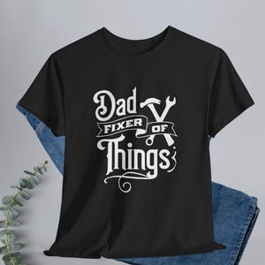 This “Dad Fixer Of Things” shirt is the perfect mix of humor and truth, making it an easy win for Father’s Day, birthdays, or just because he’s the go-to problem solver in the house. Whether he’s in the garage, tackling weekend projects, or proudly refusing to call a professional… this tee says it all.

Perfect Gift For:
Father’s Day
Husband from wife
New dads / first Father’s Day
Handy, DIY-loving dads
Mechanics, builders, and fix-it pros
The dad who already has everything