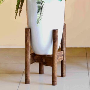 May include: A rustic wooden sign with the text "Welcome to our home" in white lettering. The sign features a distressed finish and a simple, inviting design, perfect for front door decor.