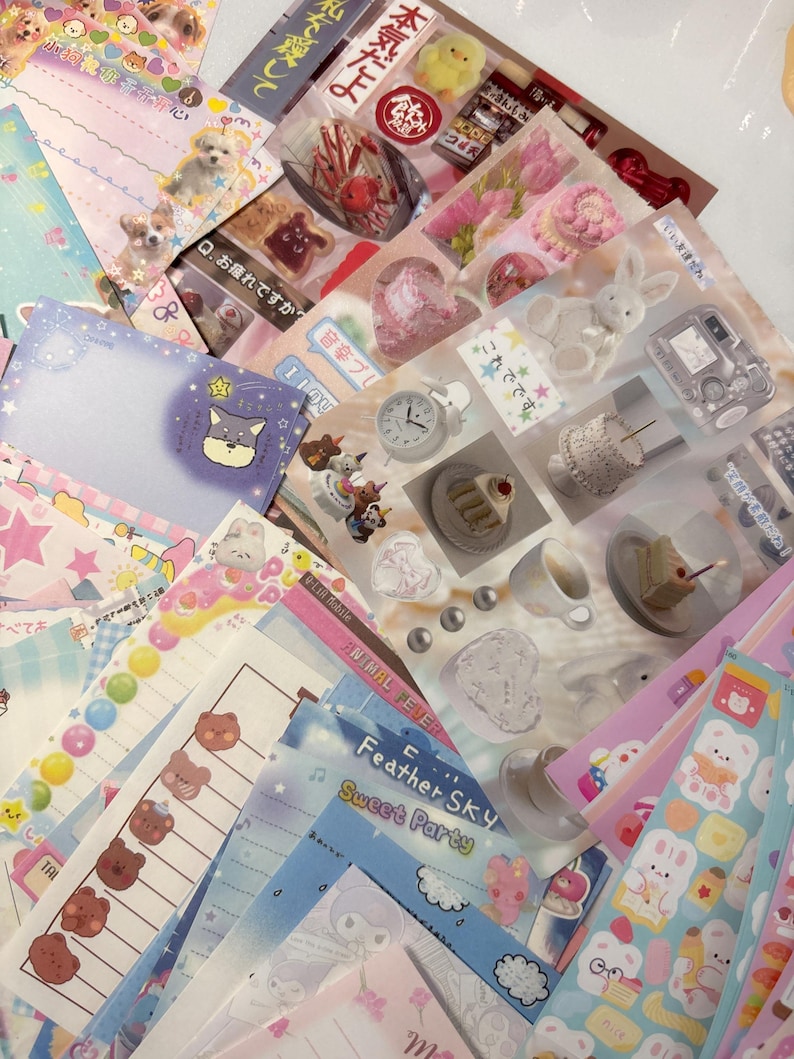 May include: A selection of colourful stationery, including stickers and notepaper, with cute illustrations of animals, food, and other decorative elements. Some items have Japanese text.
