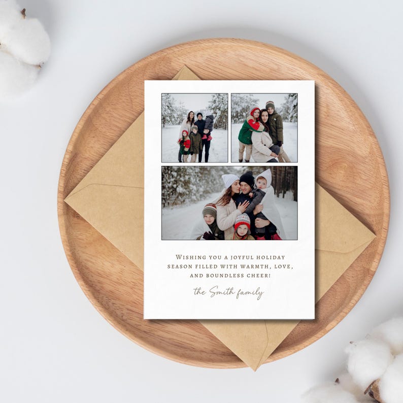 May include: A holiday card with three family photos in a snowy setting. The card has the text "Wishing you a joyful holiday season filled with warmth, love, and boundless cheer!" and the family name. The card is on a wooden tray.