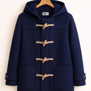 May include: Navy blue duffel coat with a hood and toggle closures. The coat has two front pockets and buttoned cuffs. The word "MAX" is visible on the label inside the hood.