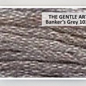 May include: A close-up of a textured fabric in a gray color. The text "THE GENTLE ART Banker's Grey 1030" is displayed above the fabric.