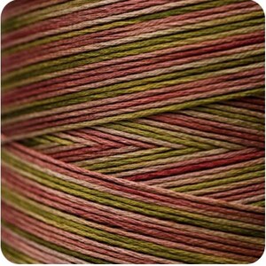 May include: Close-up of a spool of yarn with a multi-colored striped pattern in shades of green, pink, and brown.