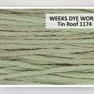May include: Close-up of a skein of Weeks Dye Works embroidery floss in the color "Tin Roof" 1174. The floss is a muted green color.