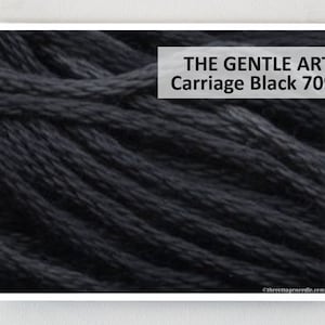 May include: Close-up of black yarn, with the text "THE GENTLE ART Carriage Black 7095" in a white rectangle. The yarn appears to be tightly wound and has a textured surface. The background is white.