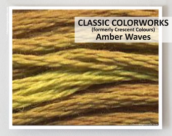 May include: Close-up of a skein of yarn in shades of brown and yellow. The yarn is called "Amber Waves" and is a Classic Colorworks brand, formerly known as Crescent Colours.