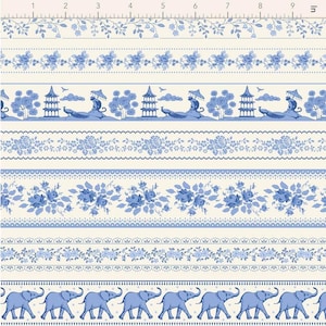 May include: A fabric design featuring various blue and white patterned borders. The borders include floral, elephant, and pagoda motifs. The design is on a cream-colored background, creating a vintage aesthetic. The image includes a ruler for scale.