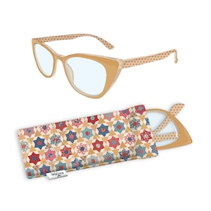 May include: Tan cat-eye eyeglasses with a star pattern on the arms, next to a matching case. The case is patterned with red, blue, and gold stars. The brand name "Riley Blake" is on the case.