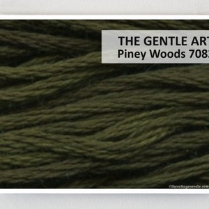 May include: Close-up of a deep green embroidery floss, showing the texture of the thread. The text "THE GENTLE ART Piney Woods 7082" is visible in the upper right corner of the image.