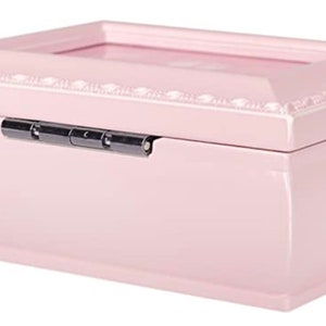 May include: A pale pink rectangular jewelry box with a hinged lid and a silver latch. The lid has a rectangular cutout for a photo.