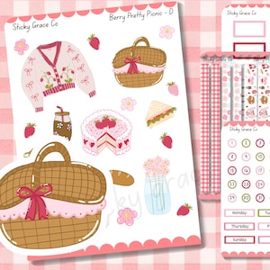 Puede incluir: Una hoja de pegatinas con temática de picnic. Las pegatinas incluyen un suéter rosa, cestas de picnic, un pastel, sándwiches y pegatinas de calendario. El texto "Berry Pretty Picnic" y "Sticky Grace Co" son visibles.