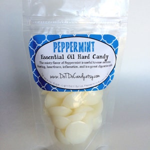 May include: A clear plastic bag filled with white peppermint hard candies. The bag has a blue and white label that reads "PEPPERMINT Essential Oil Hard Candy" and includes the website "www.DoTDoCandy.etsy.com".
