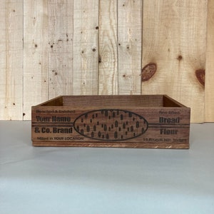 May include: A wooden box with a label that reads "Bleached & Enriched Your Name & Co. Brand Milled in YOUR LOCATION Fine Sifted Bread Flour 15 Pounds Net. Weight"