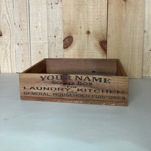 May include: A wooden box with the text "YOUR NAME" "For Soap Box" "LAUNDRY and KITCHEN" "GENERAL HOUSEHOLD PURPOSES" printed on the front.