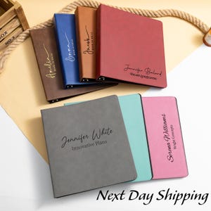 May include: A collection of personalized binders in various colors, including brown, blue, tan, and red. Each binder features a name and text, such as "Book of Ideas" and "Innovative Plans." The phrase "Next Day Shipping" is displayed at the bottom.